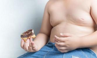 donut in obese fat boy photo