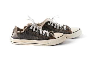 Old black sneakers isolated photo