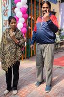 New Delhi, India - December 04 2022 - Unidentified people showing their ink-marked fingers after casting votes in front of polling booth of east Delhi area for MCD local body Elections 2022 photo