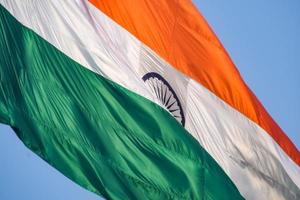 India flag flying high at Connaught Place with pride in blue sky, India flag fluttering, Indian Flag on Independence Day and Republic Day of India, tilt up shot, Waving Indian flag, Har Ghar Tiranga photo