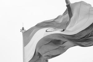 India flag flying high at Connaught Place with pride in blue sky, India flag fluttering, Indian Flag on Independence Day and Republic Day of India, tilt up shot, Waving Indian flag, Har Ghar Tiranga photo