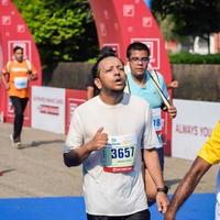 nueva delhi, india - 16 de octubre de 2022 - carrera de media maratón de vedanta delhi después de covid en la que los participantes del maratón están a punto de cruzar la línea de meta, media maratón de delhi 2022 foto