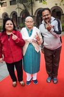 New Delhi, India - December 04 2022 - Unidentified people showing their ink-marked fingers after casting votes in front of polling booth of east Delhi area for MCD local body Elections 2022 photo