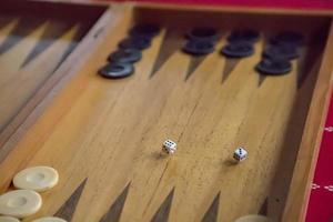 thrown dice on the table while playing backgammon photo