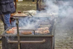Street food and outdoor cooking concept. Grilled meat street food. photo