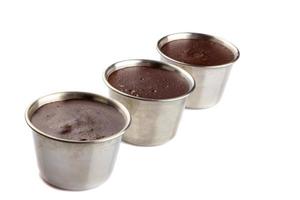 Homemade chocolate creme in a metal dessert bowl, isolated on white background. photo