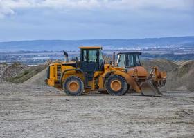 excavadora y excavador en un construcción sitio después trabajo foto