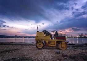 Amazing view at small roller at a construction site in a beautiful twilight photo