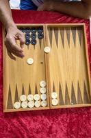 man throws dice while playing tabla photo