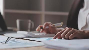 Financial analysts analyze business financial reports on a digital tablet planning investment project during a discussion at a meeting of corporate showing the results of their successful teamwork. video