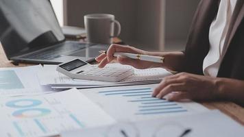 Financial analysts analyze business financial reports on a digital tablet planning investment project during a discussion at a meeting of corporate showing the results of their successful teamwork. video