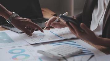 Financial analysts analyze business financial reports on a digital tablet planning investment project during a discussion at a meeting of corporate showing the results of their successful teamwork. video
