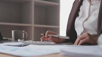 Financial analysts analyze business financial reports on a digital tablet planning investment project during a discussion at a meeting of corporate showing the results of their successful teamwork. video