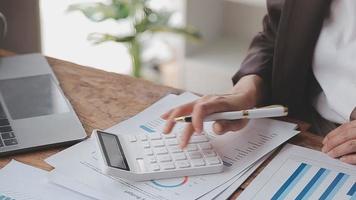 Financial analysts analyze business financial reports on a digital tablet planning investment project during a discussion at a meeting of corporate showing the results of their successful teamwork. video