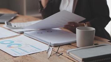 Financial analysts analyze business financial reports on a digital tablet planning investment project during a discussion at a meeting of corporate showing the results of their successful teamwork. video