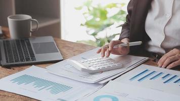 Financial analysts analyze business financial reports on a digital tablet planning investment project during a discussion at a meeting of corporate showing the results of their successful teamwork. video