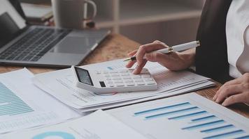 Financial analysts analyze business financial reports on a digital tablet planning investment project during a discussion at a meeting of corporate showing the results of their successful teamwork. video