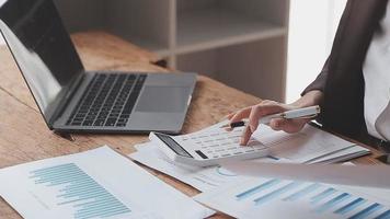 Financial analysts analyze business financial reports on a digital tablet planning investment project during a discussion at a meeting of corporate showing the results of their successful teamwork. video