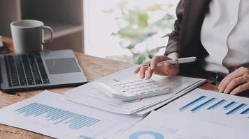 Financial analysts analyze business financial reports on a digital tablet planning investment project during a discussion at a meeting of corporate showing the results of their successful teamwork. video