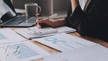 Financial analysts analyze business financial reports on a digital tablet planning investment project during a discussion at a meeting of corporate showing the results of their successful teamwork. video