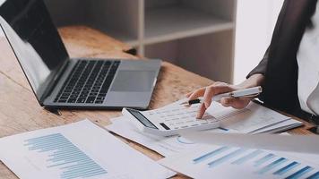 Financial analysts analyze business financial reports on a digital tablet planning investment project during a discussion at a meeting of corporate showing the results of their successful teamwork. video