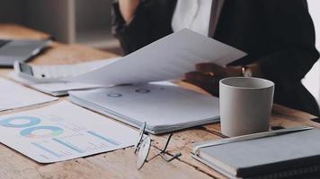 Financial analysts analyze business financial reports on a digital tablet planning investment project during a discussion at a meeting of corporate showing the results of their successful teamwork. video