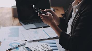 Financial analysts analyze business financial reports on a digital tablet planning investment project during a discussion at a meeting of corporate showing the results of their successful teamwork. video