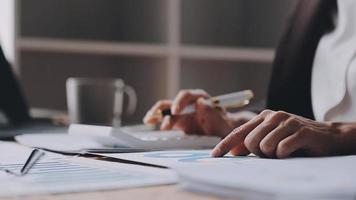Financial analysts analyze business financial reports on a digital tablet planning investment project during a discussion at a meeting of corporate showing the results of their successful teamwork. video