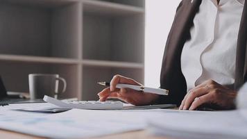 Financial analysts analyze business financial reports on a digital tablet planning investment project during a discussion at a meeting of corporate showing the results of their successful teamwork. video