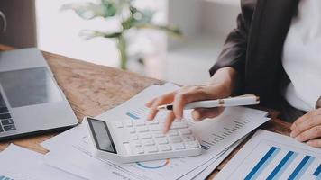 Financial analysts analyze business financial reports on a digital tablet planning investment project during a discussion at a meeting of corporate showing the results of their successful teamwork. video