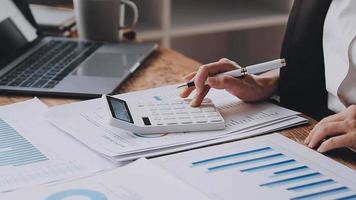 Financial analysts analyze business financial reports on a digital tablet planning investment project during a discussion at a meeting of corporate showing the results of their successful teamwork. video