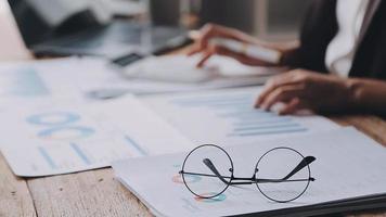 Financial analysts analyze business financial reports on a digital tablet planning investment project during a discussion at a meeting of corporate showing the results of their successful teamwork. video