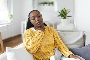 Close up of young woman rubbing her inflamed tonsils, tonsilitis problem, cropped. Woman with thyroid gland problem, touching her neck, girl has a sore throat photo