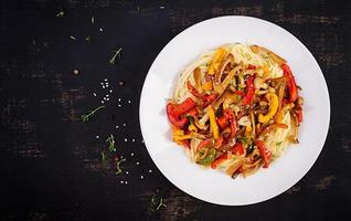 Noodles with shimeji mushrooms and paprika. Oriental meal. Japanese Shimeji mushroom stir fry. Top view photo