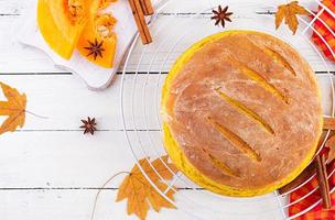 Fresh homemade pumpkin bread and pumpkin slices. Top view photo