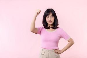 Portrait young asian woman proud and confident showing strong muscle strength arms flexed posing, feels about her success achievement. Women empowerment, equality, healthy strength and courage concept photo