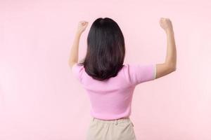 Portrait back of woman proud and confident showing strong muscle strength arms flexed posing, feels about her success achievement. Women empowerment, equality, healthy strength and courage concept photo
