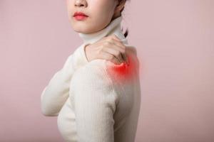 Asian young woman hold her hand on pain neck and injury ache shoulder stress problem muscle. Office syndrome disease, healthcare concept photo