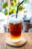 Coffee drip with coconut milk cream closeup photo