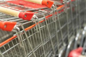 row of shopping trolleys or carts in supermarket. shopping basket. photo