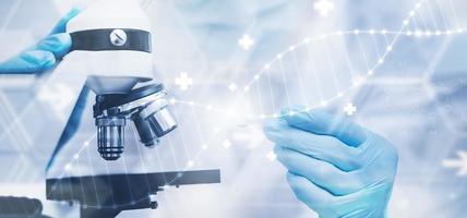 biochemical research scientist working with a microscope for the virus,Doctor touch arrow of the experimental results in a notebook, laboratory glassware containing chemical liquid for design. photo