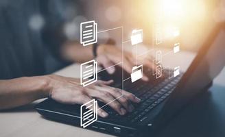 Online documentation database and document management system concept, Businessman using tablet or computer,Document Management System and Automation software to archiving and efficiently manage. photo