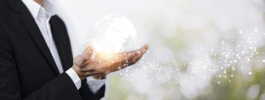 Concept Technology with line connects the world, Businessman holding hands with global connection on the nature background, global networking and global information exchange 3D rendering. photo