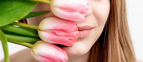 Young woman with pink tulips photo