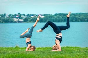 Woman and child doing handstand exercise photo