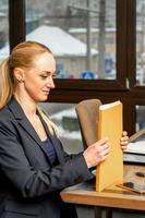 Businesswoman with folder with documents photo