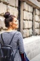 Young woman walks with backpack photo