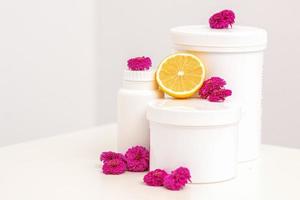 Jars with fresh lemon and flowers photo