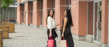 Two young women in shopping mall photo