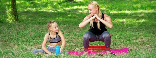 Mother and daughter doing sports exercises photo